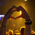 Hands forming a heart shape during a Bartour Hamburg event, symbolizing the fun and unity experienced during a pub crawl in Hamburg’s vibrant nightlife