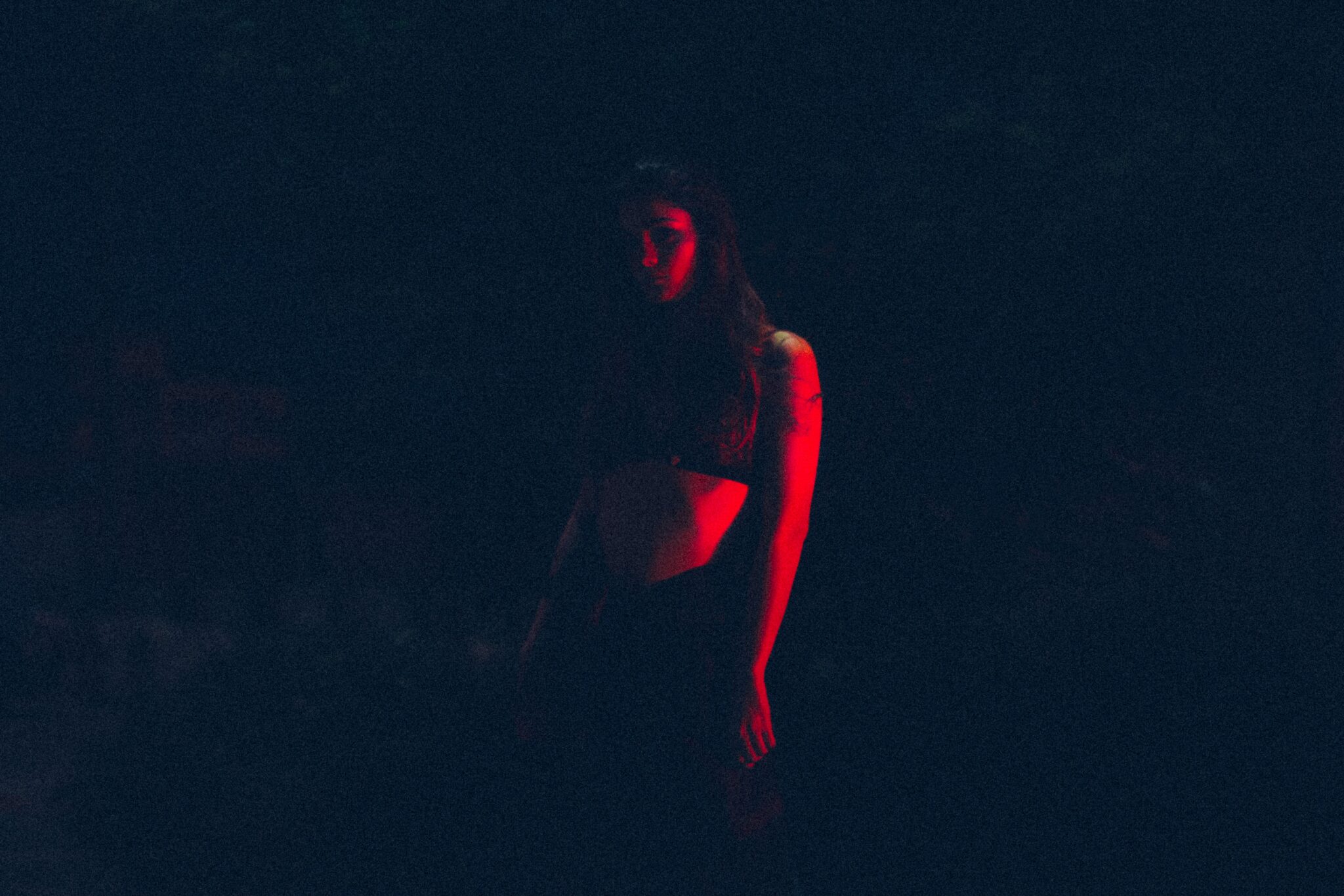 Silhouetted figure in red lighting, capturing the atmosphere of Hamburg’s Reeperbahn and the herbertrasse, Red Light District of Hamburg.