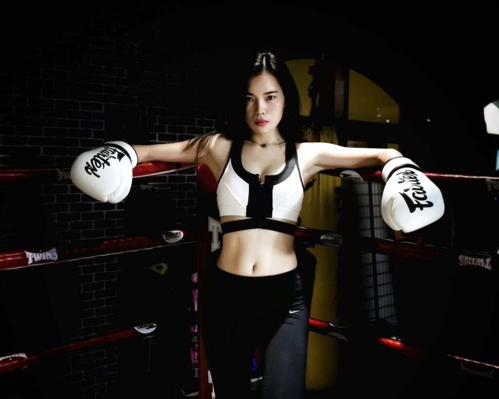 Female boxer in training at the famous Ritze bar in Hamburg’s St. Pauli district, showcasing strength and fitness in the iconic Reeperbahn nightlife scene